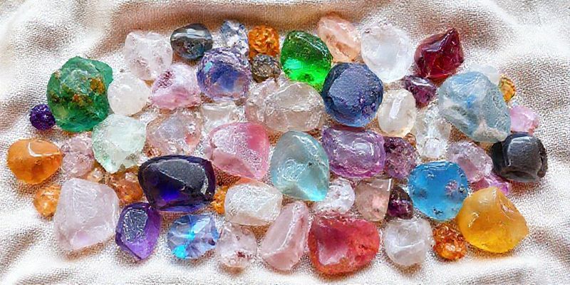 A vibrant collection of healing crystals laid out on a soft, natural fabric