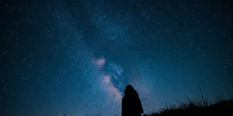 Couple looking at the starry night sky
