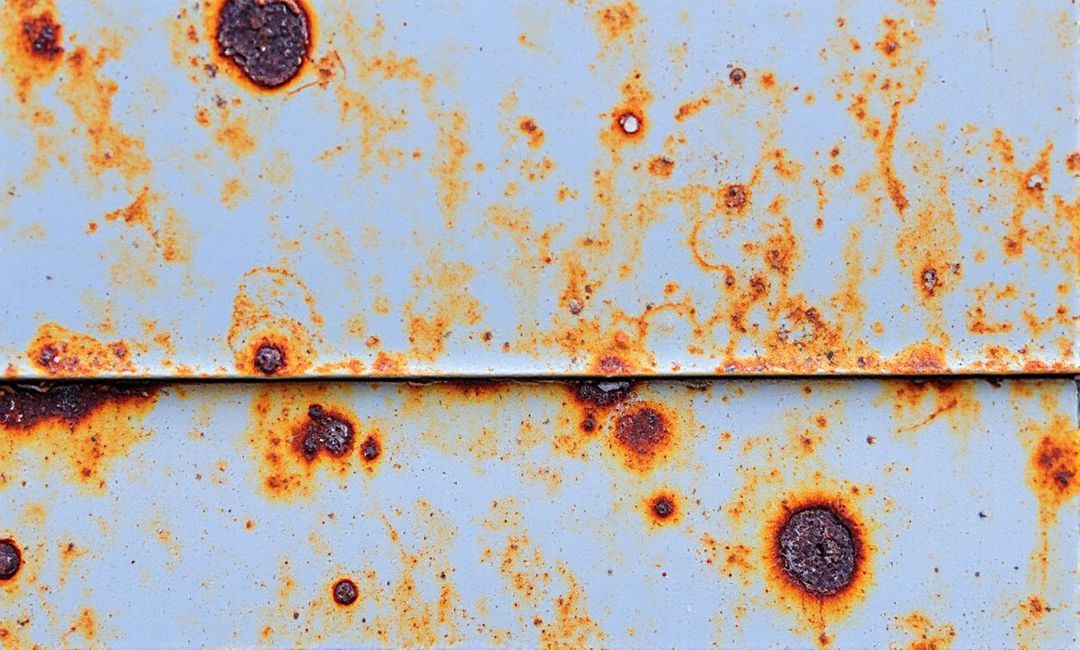 How does temperature affect corrosion in metals