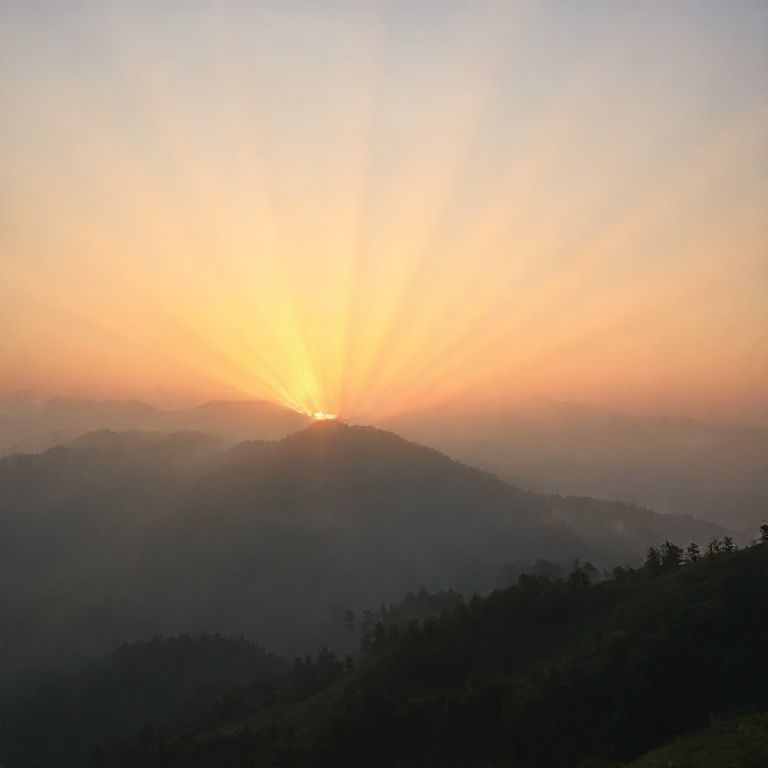 A serene mountain landscape at sunrise with golden light rays piercing through morning mist