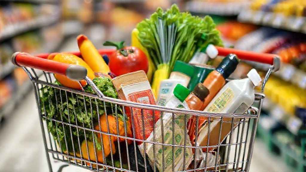 A shopping cart filled with fresh, seasonal produce, generic brand items, and bulk staples, representing smart grocery shopping for budget meal prep.